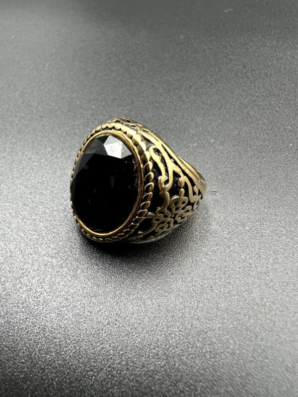 Gold oval ring with black stone